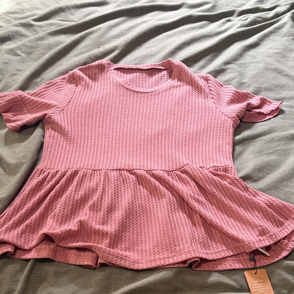 Pink Peplum top
Size M